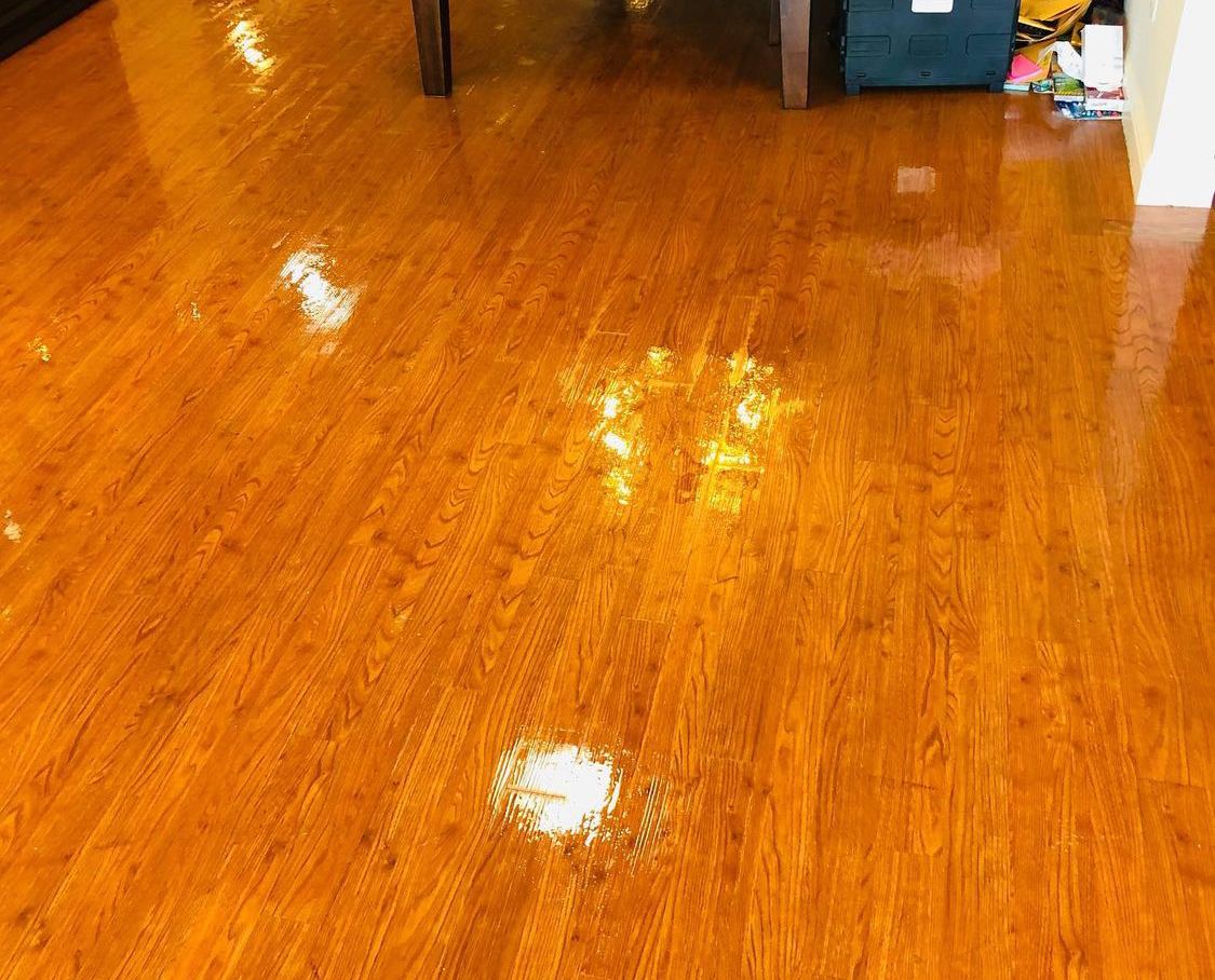 Glossy hardwood floor after deep clean in Dallas, TX